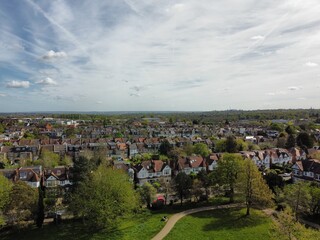 Aerial view of residential houses in Finchley, London. The image captures the greenery and suburban landscape, emphasizing tranquility and community living.