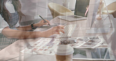 Image of person using computer over group of business people walking