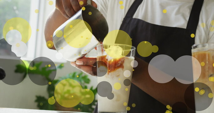 Image of falling purple dots over barista making coffee