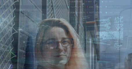 Image of financial data processing over businesswoman in office