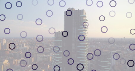 Image of falling circles over cityscape