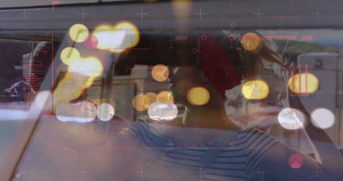 Image of digital data processing over two caucasian people in car