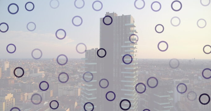 Image of falling circles over cityscape
