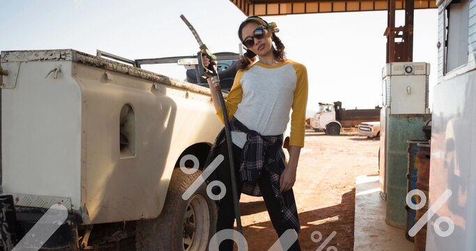 Image of percent sing over women refueling car