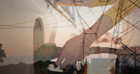 Image of electricity poles over hands of caucasian woman refueling car