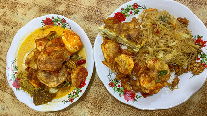 Curry Noodle and rice cooked in coconut milk, Indonesian Food served with boiled egg and fried vermicelli.