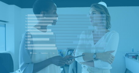 Image of graphs over diverse female coworkers in office