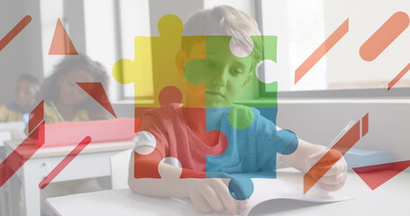 Image of puzzle pieces and shapes over diverse schoolchildren