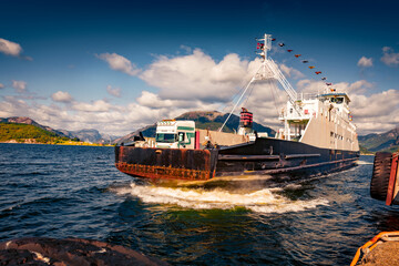Beautiful summer view of the Norwegian farry crossing through the fjord. Amazing morning seascape of North sea, Norway, Europe. Traveling concept background.