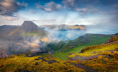Foggy morning view of popular tourist destination - Sornfelli. Fantastic summer scene of Streymoy island. Aerial seascape of Atlantic ocean, Faroe Islands, Denmark, Europe.