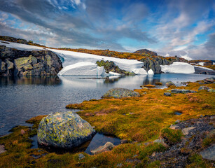 Picturesque summer view of melting snow on the side of the Aurlandsvegen - Mountain road (Bjorgavegen), Aurland in Sogn og Fjordane county, Norway.