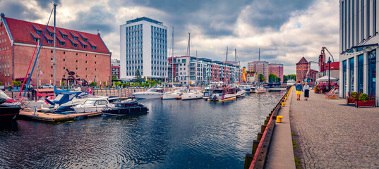 Panoramic summer cityscape of Gdansk, Poland, Europe. Gloomy afternoon scene of Martwa Wisla river with a lots of luxury yachts. Traveling concept background.