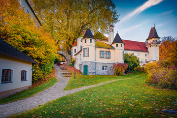 Colorful autumn scenery. Stunning morning view of Soos castle. Astonishing autumn cityscape of Soos villige, Austria, Europe. Beauty of countryside concept background. .