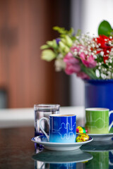 A welcome gesture at a hotel, Turkish coffee for two with chocolate and water on a marble tabletop in a hotel room setting with soft window light