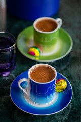 A welcome gesture at a hotel, Turkish coffee for two with chocolate and water on a marble tabletop in a hotel room setting with soft window light