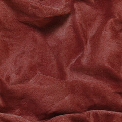 Rich seamless texture of crumpled fabric in warm reddish tones for design and artistic projects