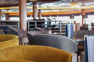 Cozy living room atmosphere inside cafe café coffee shop bar lounge bistro onboard luxury cruiseship cruise ship liner in contemporary Art Deco interior design