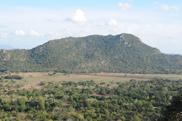 Beautiful natural green landscape from Mihintale mountain peak near Anuradhapura city in Sri Lanka in the afternoon with blue sky