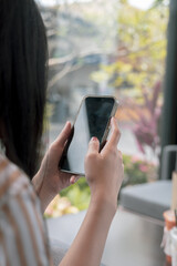 Close-up view of smartphone on hands of female in cafe on holiday. Concept for business contact interpersonal communication technology device.