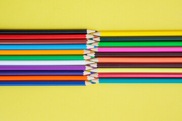 Colored pencils on a yellow background. Bright juicy background for inscriptions. Summer...