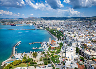 Panoramic aerial view of the cityscape of Volos, Magnesia, Greece, with Agios Konstantinos church and yacht marina