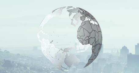 Image of spinning globe over cityscape