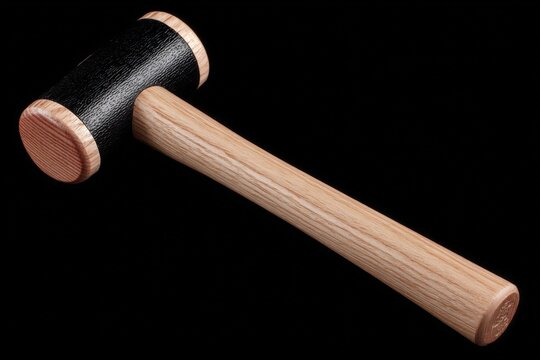 Black and wooden mallet on a dark background for woodworking and crafting projects - Powered by Adobe
