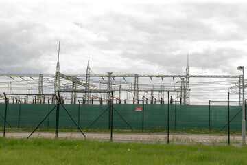 This image showcases an electrical substation, which prominently features various high voltage...