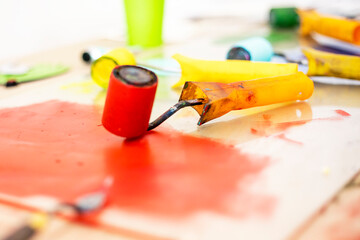 desktop graphics with a roller with red paint and a palette knife