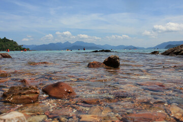 Shallow Crystal Waters with Rocky Foreground. Clear shallow sea with colorful pebbles and rocks...