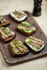 Sandwiches with sprats, mayonnaise and cucumber