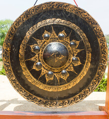 Traditional Thai Gong with Golden Patterns. Black traditional gong with golden design details, used in temple ceremonies and spiritual rituals in Thailand.