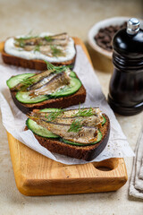 Sandwiches with sprats, mayonnaise and cucumber
