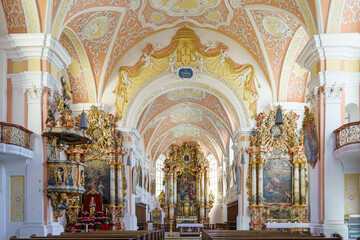 Intricate architecture of a baroque church interior adorned with frescoes and sculptures in...