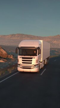 A long distance semi truck with cargo trailer driving on a desert road into the sunset. Front low angle view. Car POV. 3d animation rendering. Vertical Video