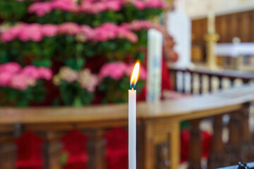 Candlelight shines against floral backdrop in serene location during special ceremony