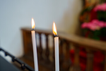 Candles flicker in a serene church setting during a spiritual gathering