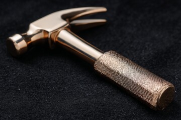 High-quality hammer resting on a textured surface showcasing its shiny metal finish and detailed craftsmanship