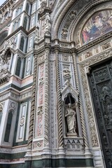 A fragment of the Cathedral of Santa Maria del Fiore facade with rich decoration, Florence, Italy