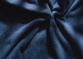 Abstract structure- wrinkles on the fabric. Textile-  simple dark background