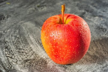 Drops of water on a ripe apple - appetizing and healthy food