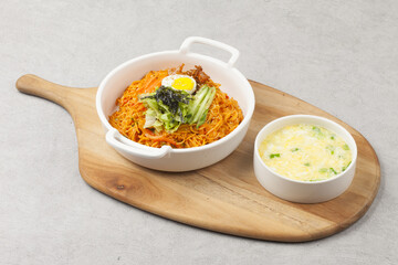 Bibim guksu is a type of noodle dish that is eaten without soup, mixed with meat, vegetables, and various seasonings.