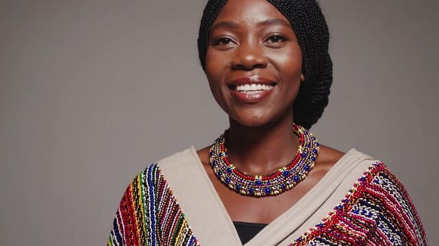 Portrait of a Zulu woman showcasing different expressions of happiness and joy, isolated on a gray background