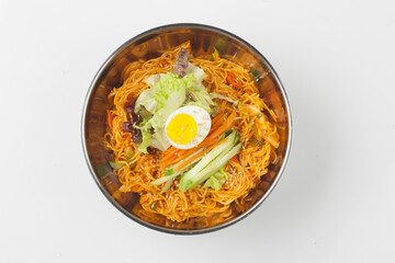 Bibim guksu is a type of noodle dish that is eaten without soup, mixed with meat, vegetables, and various seasonings.