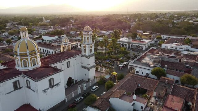 The San Miguel Arcangel church and the main plaza of Comala on a sunny Sunday evening