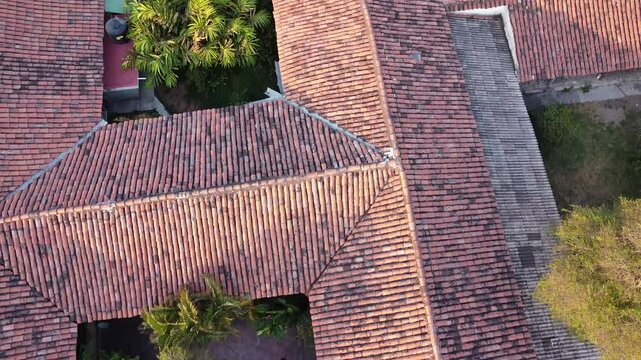 Drone view from the red tile roofs to the church of San Miguel Arcangel in the magic town of Comala