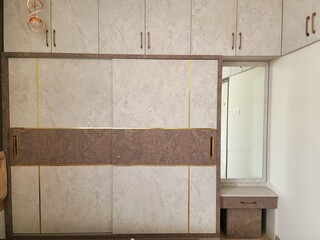 Modern modular wardrobe with sliding doors in a matte marble finish, brown and beige panels,...