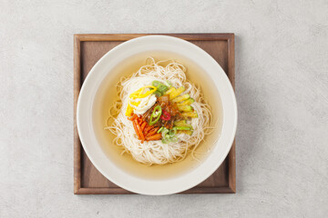 Naklejka premium Janchi Guksu refers to noodles that are mainly eaten on feast days. It is a dish made with noodles in a hot clear soup and various toppings.