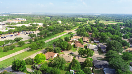 University campus and golf course near middle class residential neighborhood in Cockrell Hill, South Dallas, Texas, row of single-family houses well established landscape, mature tree, lush green