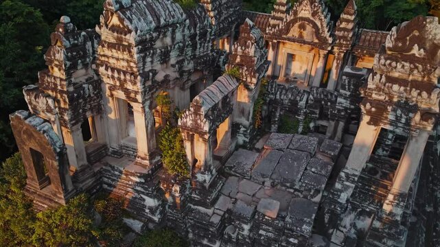 Koh ker temple, a hidden gem of angkorian architecture, reveals its intricate carvings and weathered stones as the sun casts a warm glow upon its majestic ruins